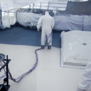 Pentech S6MM Non-Skid Spray Machine being used to coat the fore deck of a U.S. Navy Destroyer